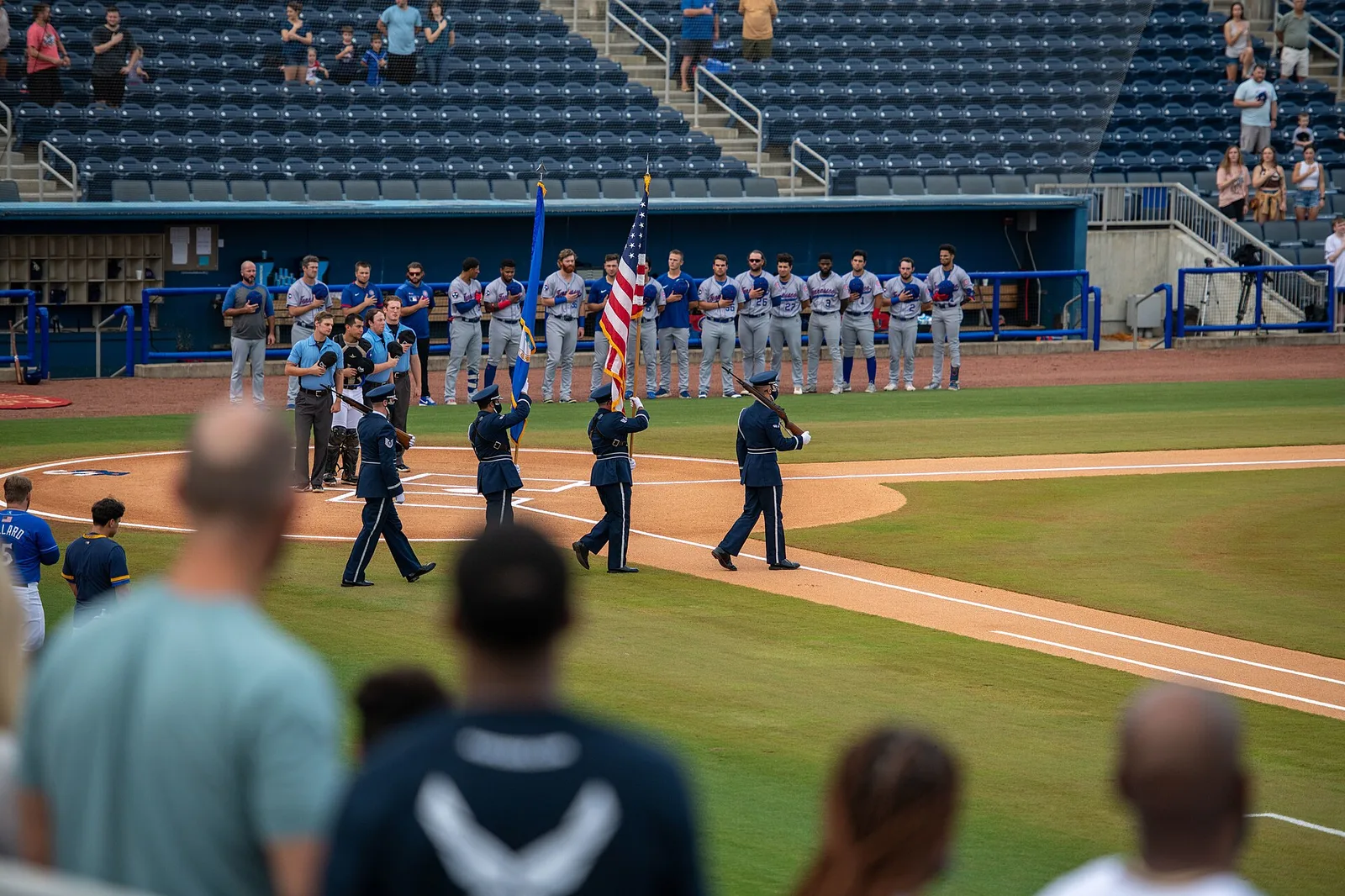 Fans and players stand for the national anthem at a Biloxi Shuckers game at Keesler Federal Park.