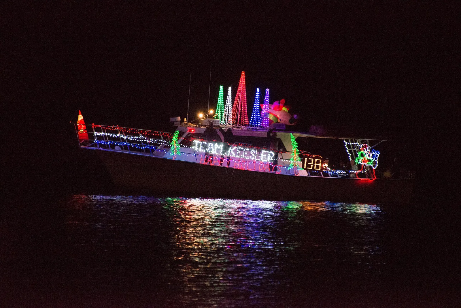 The Keesler Dolphin passes the judging boat during the Christmas on the Water boat parade in Biloxi.