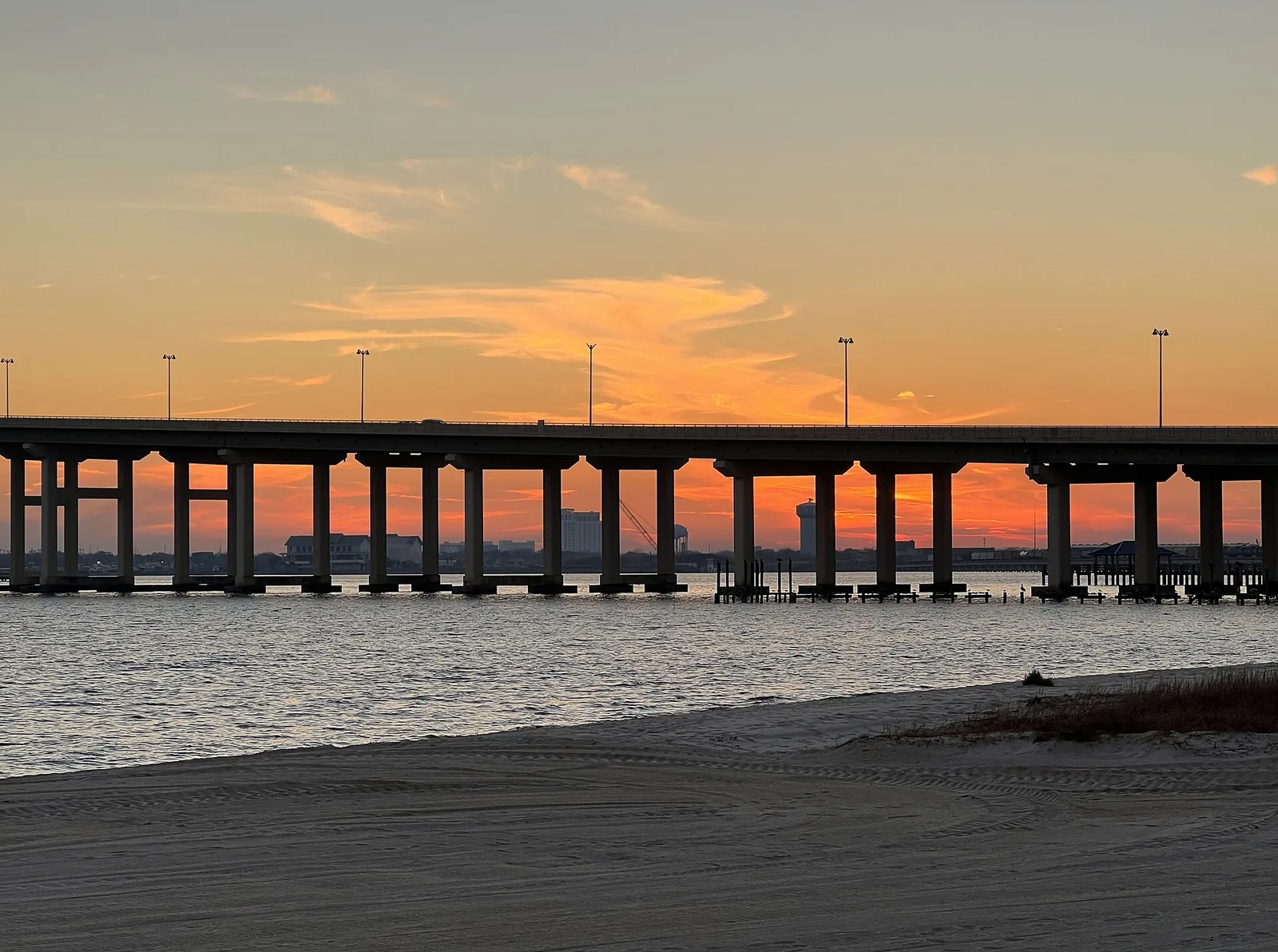 The Biloxi Bay Bridge seen from Front Beach in Ocean Springs; Biloxi's fireworks are best seen from the beach between the lighthouse and the bridge.