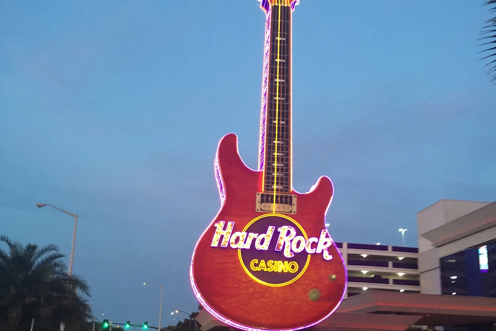 The guitar-shaped sign at Hard Rock Hotel and Casino on Beach Boulevard in Biloxi, lit at dusk.