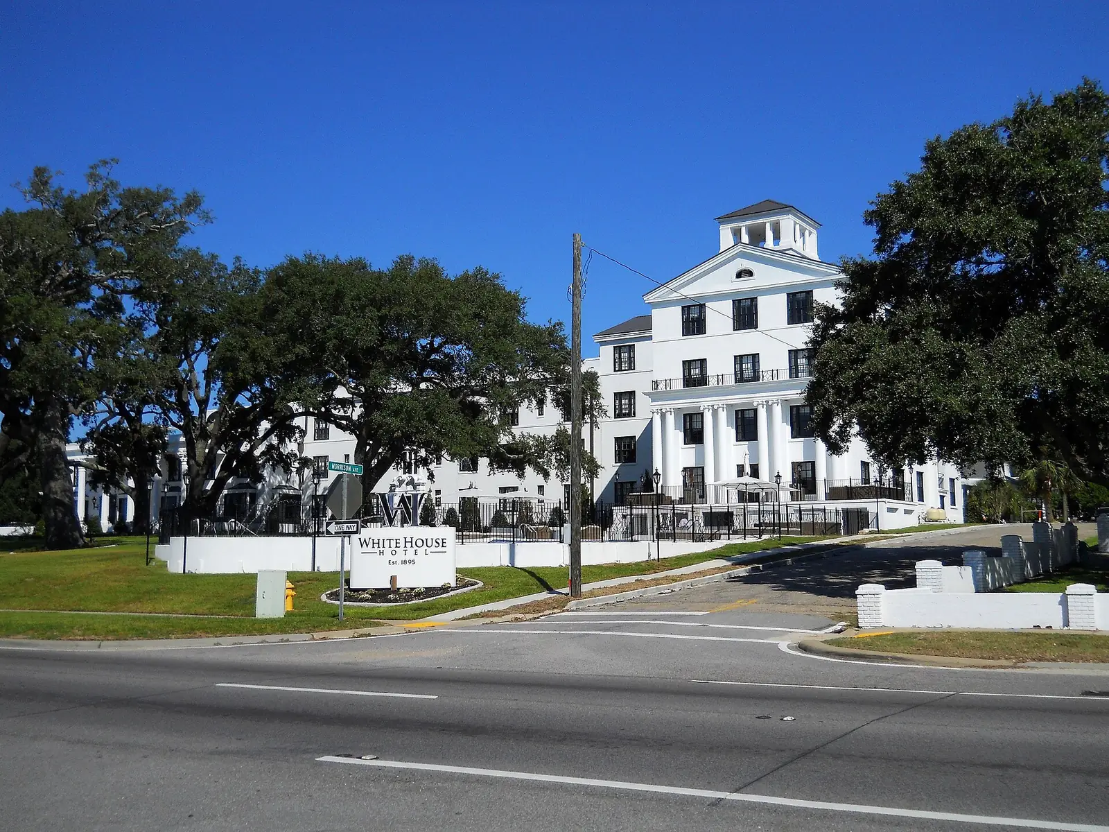 The White House Hotel, home of Cora's restaurant, under live oaks on Beach Boulevard in Biloxi.