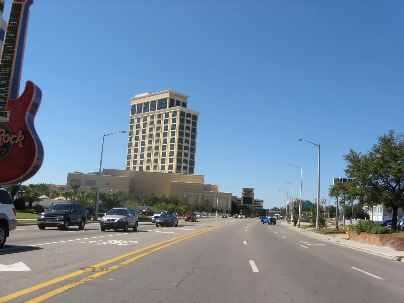 U.S. 90 at the south edge of downtown Biloxi, with the Hard Rock guitar sign at left and the Beau Rivage tower ahead.