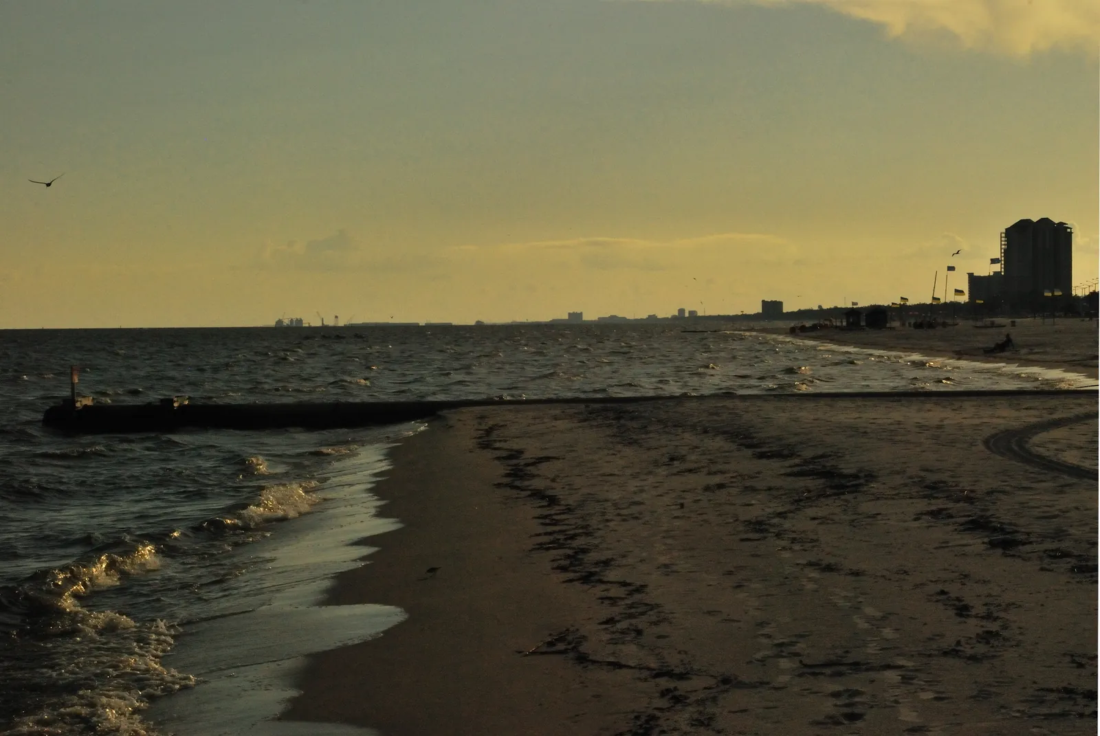 The sand beach in West Biloxi near Beauvoir at dusk, looking west along the Mississippi Sound toward Gulfport.