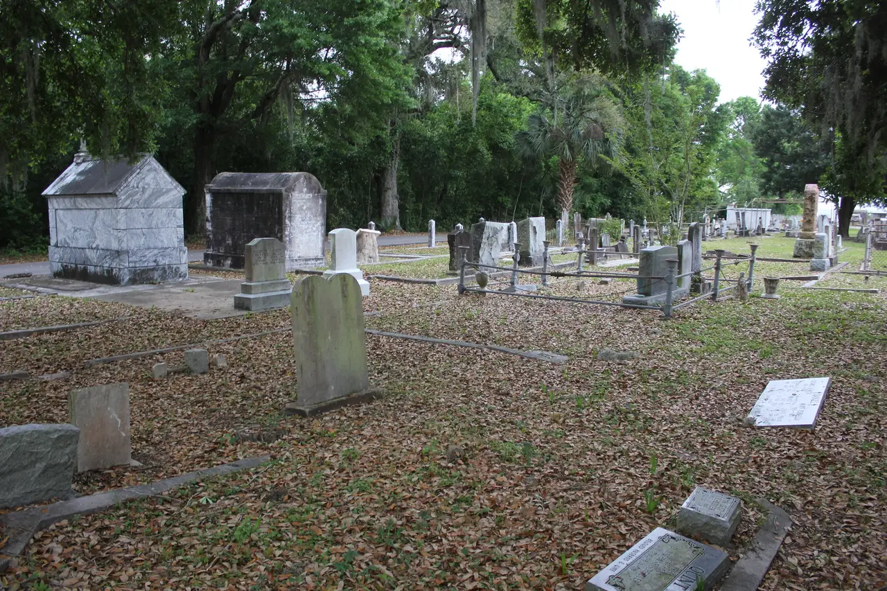 Tombs and headstones under live oaks in the Old Biloxi Cemetery on Irish Hill Drive.
