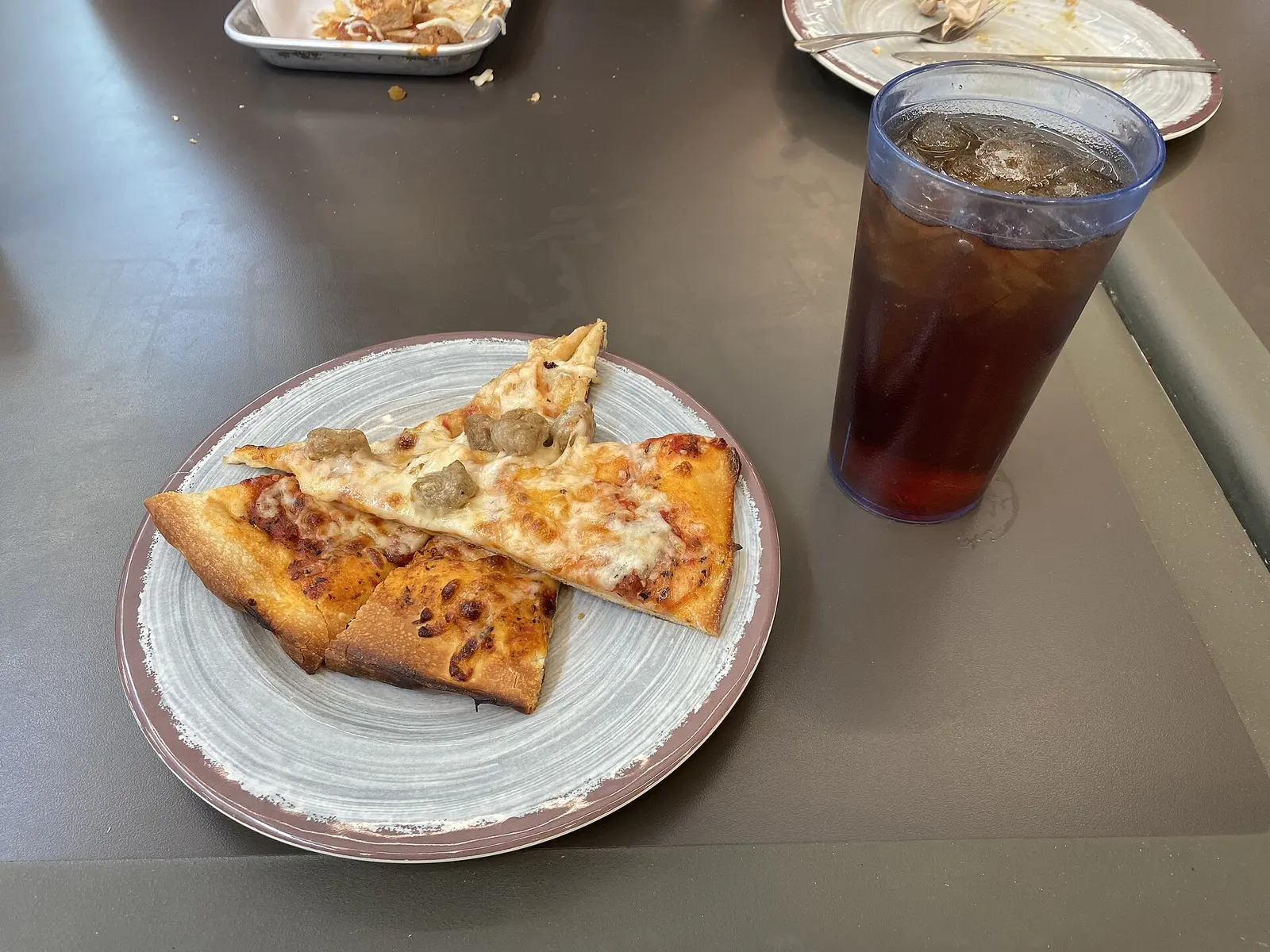 A pizza served with a glass of sweet tea at a Mississippi restaurant.